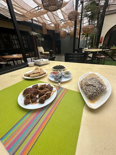 Aliya dry-fried beef with brown ugali in the courtyard